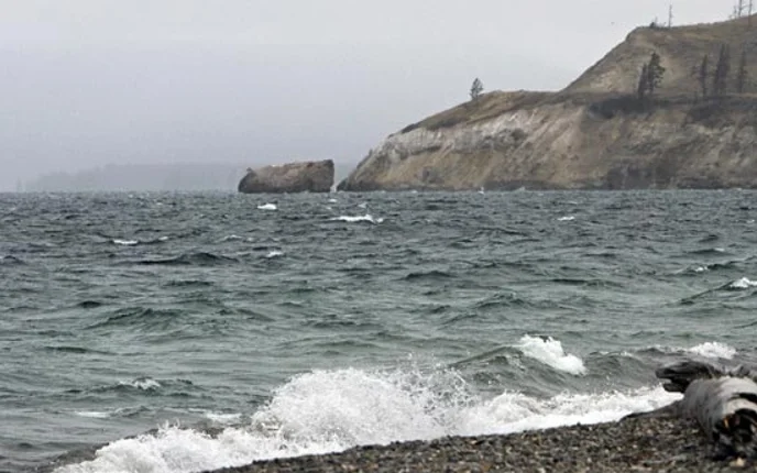 Small waves crash on a rocky shore