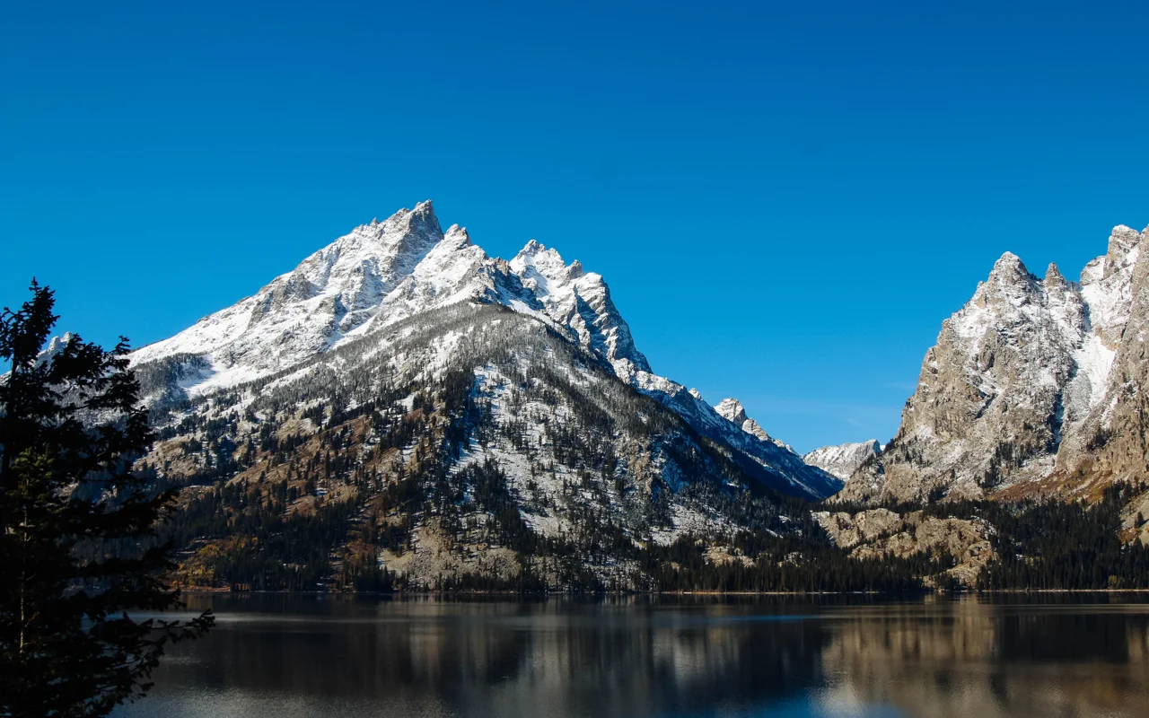 Mountains rise out of a calm lake.